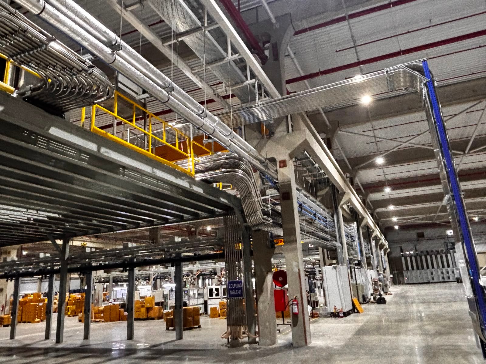 Elevated process piping and structural framework inside an industrial facility